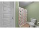 Bathroom with toilet and colorful shower curtain at 179 Carrie Dr, Archer Lodge, NC 27527