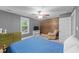 Comfortable bedroom with wood accent wall and plenty of natural light at 179 Carrie Dr, Archer Lodge, NC 27527