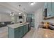 Open-concept kitchen featuring granite countertops, stainless appliances, and breakfast bar overlooking the living room at 179 Carrie Dr, Archer Lodge, NC 27527