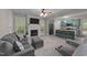 Open-concept living room with fireplace, adjoined to a kitchen with an island and breakfast bar at 179 Carrie Dr, Archer Lodge, NC 27527