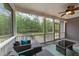 Relaxing screened porch with stylish furniture and a tranquil view of the backyard at 179 Carrie Dr, Archer Lodge, NC 27527