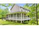 Rear view of the home with a screened-in porch, outdoor patio, and beautifully maintained backyard at 179 Carrie Dr, Archer Lodge, NC 27527