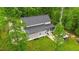 Aerial view of the rear exterior with gray siding, screened porch, and manicured lawn at 179 Carrie Dr, Archer Lodge, NC 27527