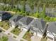 An aerial view featuring houses by a serene lake, showcasing the well-maintained landscaping and neighborhood at 1824 Amberly Ledge Way, Cary, NC 27519