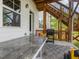 A cozy back patio with a table, grill, and wooden stairs leading to a deck, perfect for outdoor dining and entertaining at 1824 Amberly Ledge Way, Cary, NC 27519