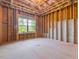 Unfinished basement with exposed frame and window, offering potential for future living space at 1824 Amberly Ledge Way, Cary, NC 27519