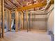Unfinished basement with wood framing, concrete floor and walls, offering ample space for customization at 1824 Amberly Ledge Way, Cary, NC 27519