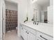 Well-lit bathroom with a white vanity, black hardware, and a shower/tub combo at 1824 Amberly Ledge Way, Cary, NC 27519