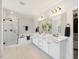 Bright bathroom featuring a double sink vanity, soaking tub, and glass enclosed shower at 1824 Amberly Ledge Way, Cary, NC 27519