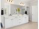 Bathroom featuring double sinks, white cabinetry, and neutral flooring with a view to the ensuite bathroom at 1824 Amberly Ledge Way, Cary, NC 27519