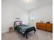 Bright bedroom with a twin bed, dresser, and a window overlooking the outdoors at 1824 Amberly Ledge Way, Cary, NC 27519