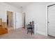 Spare bedroom featuring a small desk and chair with access to the hallway and a bathroom at 1824 Amberly Ledge Way, Cary, NC 27519
