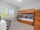Cozy ' bedroom with a wooden bunk bed, a desk, and a window for natural light at 1824 Amberly Ledge Way, Cary, NC 27519
