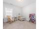 Bright Bedroom with a rocking chair, crib, dollhouse, and plenty of natural light from the window at 1824 Amberly Ledge Way, Cary, NC 27519