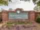 Community entrance sign for Residents' Club at Amberly, set within a brick structure and manicured landscaping at 1824 Amberly Ledge Way, Cary, NC 27519