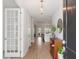 Inviting entryway with hardwood floors, decorative console table, and view to the kitchen at 1824 Amberly Ledge Way, Cary, NC 27519