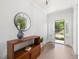 Open entryway features hardwood floors, a console table, and access to the front door at 1824 Amberly Ledge Way, Cary, NC 27519