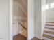 Hallway featuring a staircase, natural lighting, and an unfinished room in the distance at 1824 Amberly Ledge Way, Cary, NC 27519