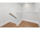 Hallway with hardwood flooring with white trim and walls at 1824 Amberly Ledge Way, Cary, NC 27519