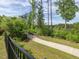 Scenic community walking path surrounded by lush greenery, offering a peaceful and natural setting at 1824 Amberly Ledge Way, Cary, NC 27519