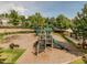 Community playground with slides, climbing structures, and seating, surrounded by mature trees at 1824 Amberly Ledge Way, Cary, NC 27519