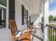Relaxing porch with two rocking chairs and striped pillows at 1824 Amberly Ledge Way, Cary, NC 27519