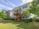 Back exterior featuring a covered deck and porch, with steps leading to the backyard at 1824 Amberly Ledge Way, Cary, NC 27519