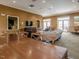 Spacious recreation room with a large wooden table, cozy seating area, and a TV for entertainment at 1824 Amberly Ledge Way, Cary, NC 27519