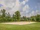 Outdoor sand volleyball court surrounded by lush landscaping and green space in the community at 1824 Amberly Ledge Way, Cary, NC 27519