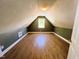 Finished attic with wood-look flooring, a neutral color palette, and natural light at 1846 Forest Wood Rd, Rocky Mount, NC 27804