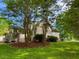 Backyard with a grassy lawn, landscaping, a wooden deck, and a view of the house at 1846 Forest Wood Rd, Rocky Mount, NC 27804
