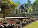 Expansive backyard deck and stone-bordered flower bed offer lovely outdoor living and entertaining space at 1846 Forest Wood Rd, Rocky Mount, NC 27804
