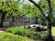 Serene backyard view with a large wooden deck, lush greenery, and meticulous landscaping at 1846 Forest Wood Rd, Rocky Mount, NC 27804