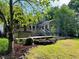 Private backyard featuring a deck for outdoor living and entertaining with beautiful landscaping at 1846 Forest Wood Rd, Rocky Mount, NC 27804