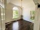 Bedroom with beautiful hardwood floors, a large window, chandelier, and neutral paint at 1846 Forest Wood Rd, Rocky Mount, NC 27804