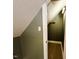 A closet with a slanted ceiling and wooden shelf, providing extra storage space at 1846 Forest Wood Rd, Rocky Mount, NC 27804
