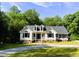 Charming two-story home with dormer windows and a well-maintained yard, surrounded by lush greenery at 1846 Forest Wood Rd, Rocky Mount, NC 27804