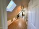 Hallway features wood-look flooring, a skylight, and access to other rooms at 1846 Forest Wood Rd, Rocky Mount, NC 27804
