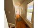 Hallway with hardwood floors, classic trim, and lots of natural light leading to various rooms at 1846 Forest Wood Rd, Rocky Mount, NC 27804