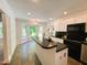 Bright kitchen boasts a center island, black countertops, stainless appliances, and bay window at 1846 Forest Wood Rd, Rocky Mount, NC 27804