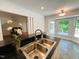 Kitchen sink with stainless faucet overlooks a sunny breakfast nook and outdoor deck at 1846 Forest Wood Rd, Rocky Mount, NC 27804