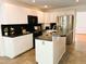 Stylish kitchen featuring white cabinetry, black countertops, and stainless steel appliances at 1846 Forest Wood Rd, Rocky Mount, NC 27804