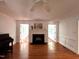 Bright living room features hardwood floors, elegant trim, fireplace, and double french doors at 1846 Forest Wood Rd, Rocky Mount, NC 27804