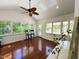 Bright sunroom with hardwood floors, lots of natural light, ceiling fan, and access to the outdoors at 1846 Forest Wood Rd, Rocky Mount, NC 27804