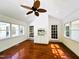 Bright sunroom with hardwood floors, lots of natural light, ceiling fan, and access to the outdoors at 1846 Forest Wood Rd, Rocky Mount, NC 27804