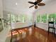 Bright sunroom with hardwood floors, lots of natural light, ceiling fan, and access to the outdoors at 1846 Forest Wood Rd, Rocky Mount, NC 27804