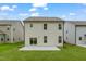 View of the back of the house with a new lawn, and a patio with sliding glass doors at 2007 Seford Dr, Durham, NC 27703