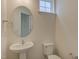 Half bathroom featuring pedestal sink, toilet, and modern finishes at 2007 Seford Dr, Durham, NC 27703