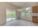 Bright dining area features a modern chandelier and sliding glass doors to the backyard at 2007 Seford Dr, Durham, NC 27703