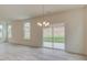 Bright dining area features a modern chandelier and sliding glass doors to the patio at 2007 Seford Dr, Durham, NC 27703